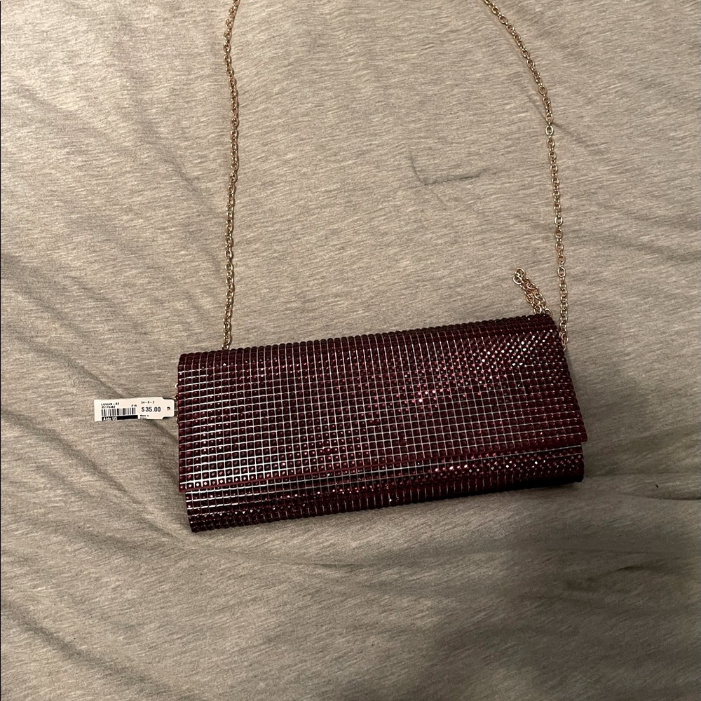 Red Aldo clutch with removable chain.